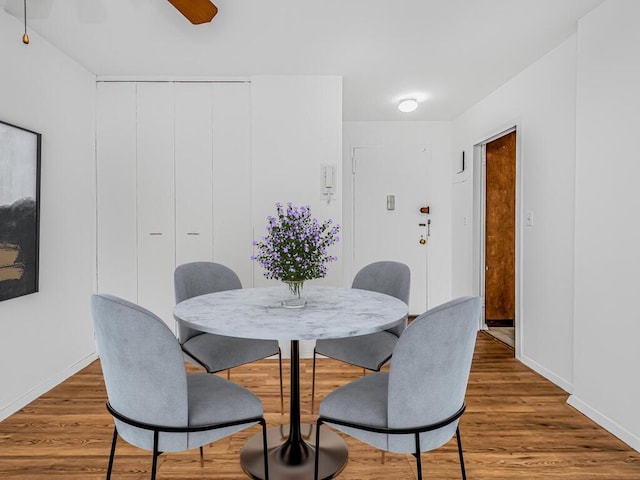 dining space featuring ceiling fan and hardwood / wood-style floors