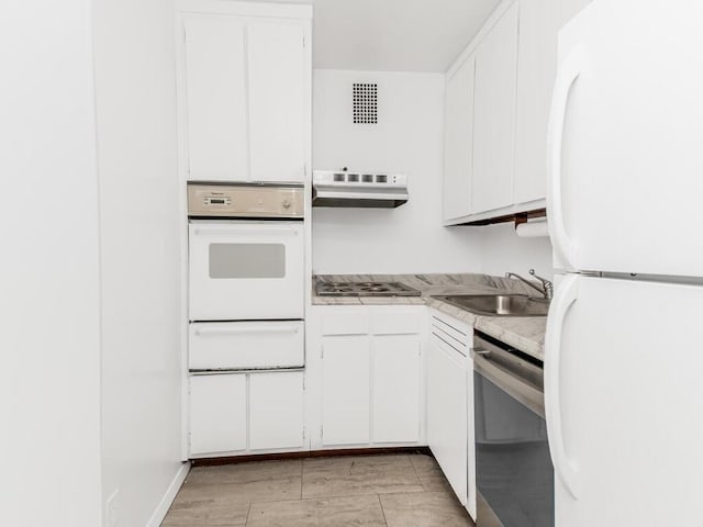 kitchen with white cabinets, appliances with stainless steel finishes, and sink