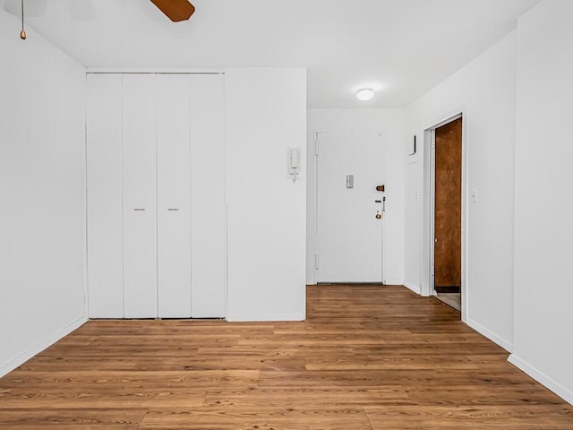 interior space featuring hardwood / wood-style floors, ceiling fan, and a closet