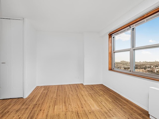 unfurnished room with light hardwood / wood-style flooring