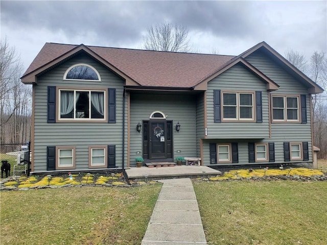 split foyer home with a front lawn