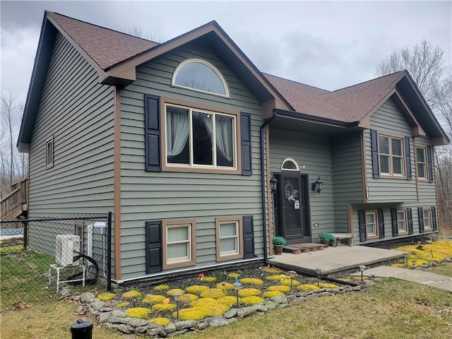 bi-level home featuring a patio area and a front yard