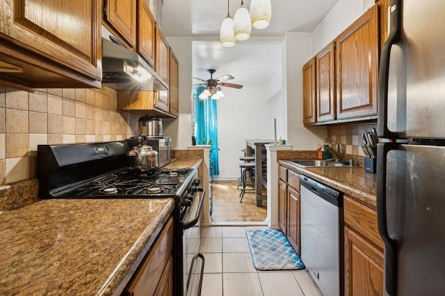 kitchen featuring ceiling fan, sink, decorative light fixtures, light tile patterned flooring, and appliances with stainless steel finishes