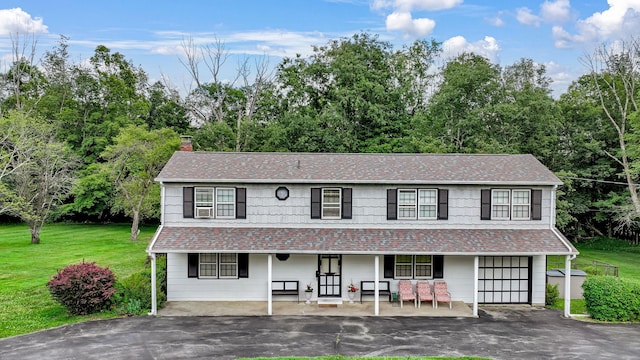 138 Reinhardt Rd, Middletown, NY 10940 - view of front of property with a chimney, a porch, driveway, a front yard, and a shingled roof