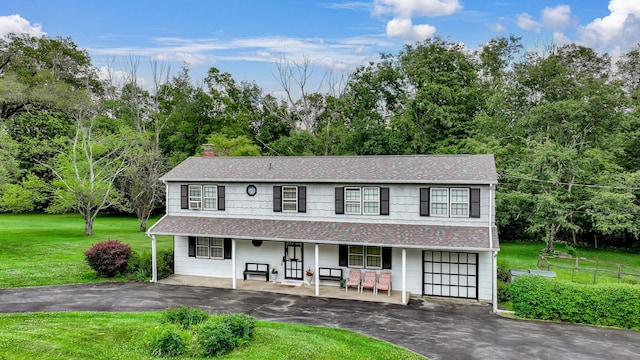 138 Reinhardt Rd, Middletown, NY 10940 - view of front of property with driveway, covered porch, a front lawn, roof with shingles, and a chimney