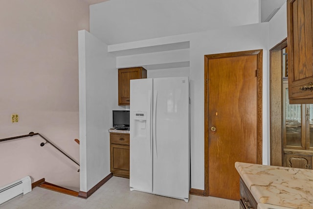 138 Reinhardt Rd, Middletown, NY 10940 - kitchen with white fridge with ice dispenser, baseboard heating, brown cabinetry, and light floors
