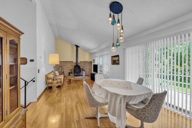 138 Reinhardt Rd, Middletown, NY 10940 - dining room featuring a wood stove, light wood-style flooring, and lofted ceiling