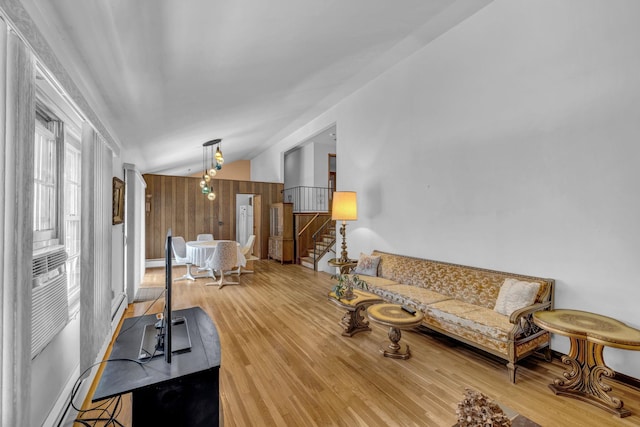 138 Reinhardt Rd, Middletown, NY 10940 - living area featuring vaulted ceiling, wood finished floors, stairs, and a baseboard heating unit