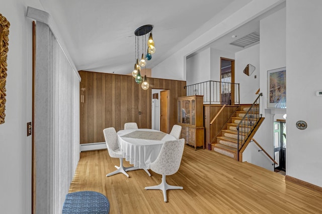138 Reinhardt Rd, Middletown, NY 10940 - dining area featuring wooden walls, wood finished floors, stairs, and a baseboard heating unit