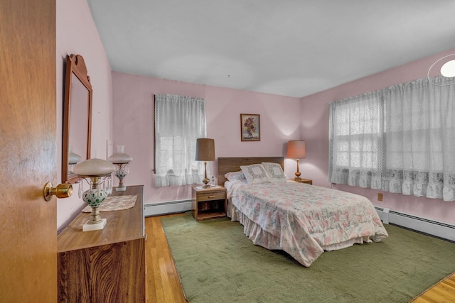 138 Reinhardt Rd, Middletown, NY 10940 - bedroom featuring a baseboard radiator, wood finished floors, and multiple windows