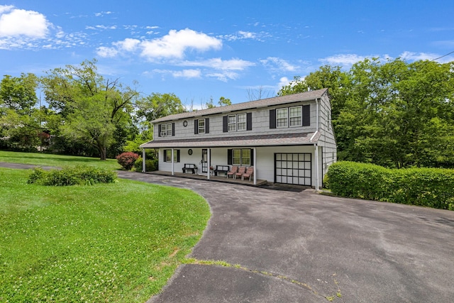 138 Reinhardt Rd, Middletown, NY 10940 - view of front of home featuring covered porch, a front lawn, asphalt driveway, a shingled roof, and a garage