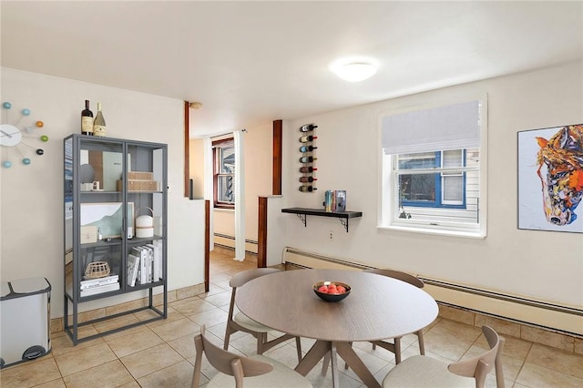 dining space featuring light tile patterned flooring and a baseboard heating unit