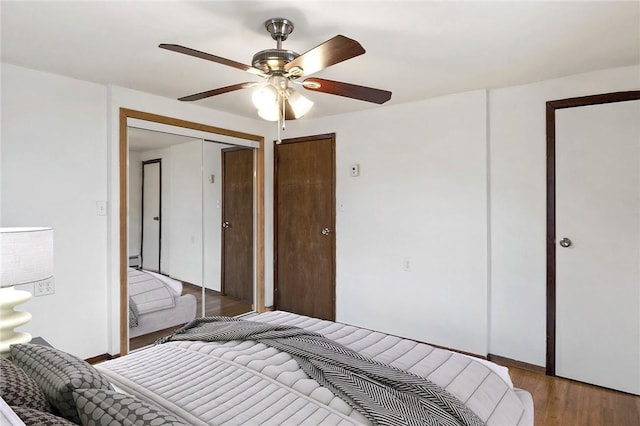 bedroom with hardwood / wood-style floors, a closet, and ceiling fan