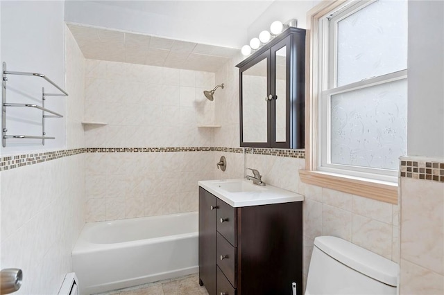 full bathroom with vanity, toilet, tile walls, and tiled shower / bath