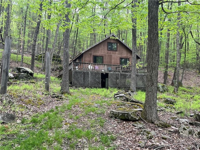 rear view of house featuring a deck