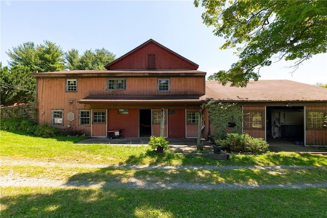 back of house with a patio area and a yard