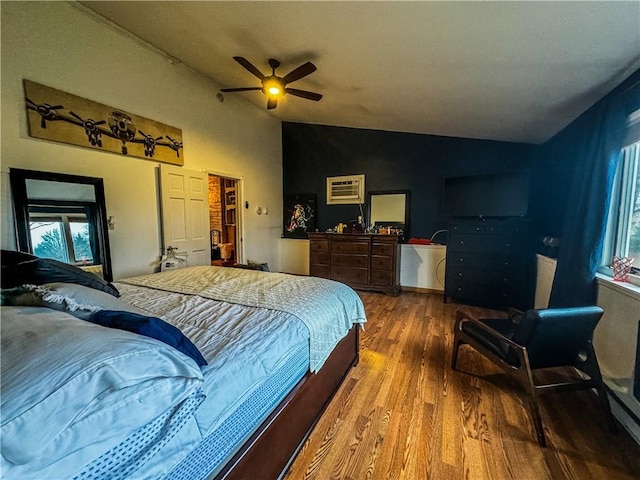 bedroom with ceiling fan, a spacious closet, wood-type flooring, lofted ceiling, and a closet