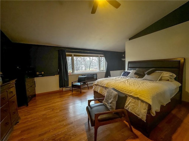 bedroom featuring wood-type flooring, vaulted ceiling, and ceiling fan