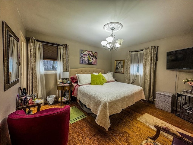 bedroom featuring dark hardwood / wood-style floors and a notable chandelier