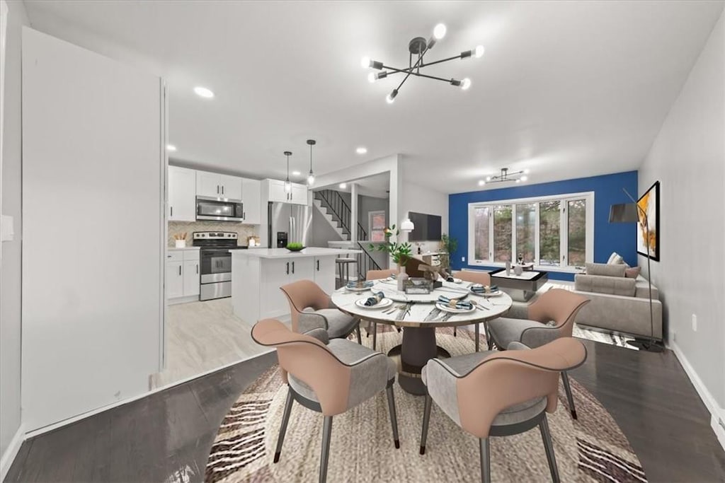 dining space featuring a chandelier and light wood-type flooring