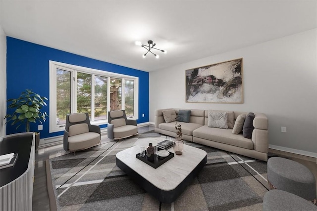 living room with hardwood / wood-style flooring and a notable chandelier