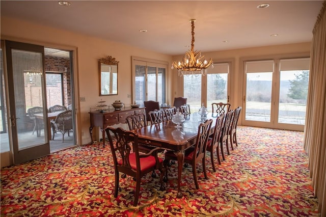 dining area featuring french doors and a notable chandelier