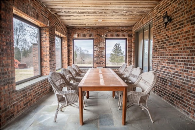 unfurnished sunroom featuring wood ceiling