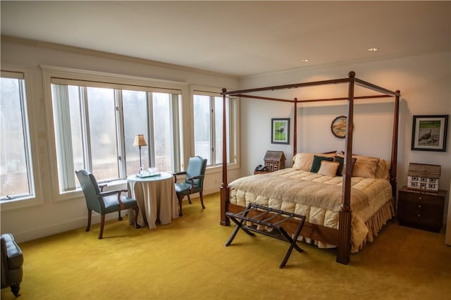 carpeted bedroom featuring multiple windows and crown molding