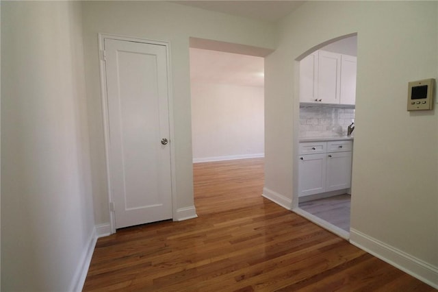 hallway with dark hardwood / wood-style flooring