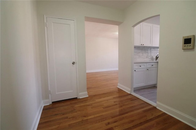 5645 Netherland Ave Unit 6A, Bronx, NY 10471 - corridor featuring wood finished floors, arched walkways, and baseboards