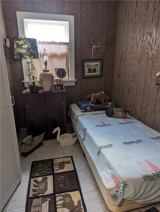 bedroom featuring wooden walls