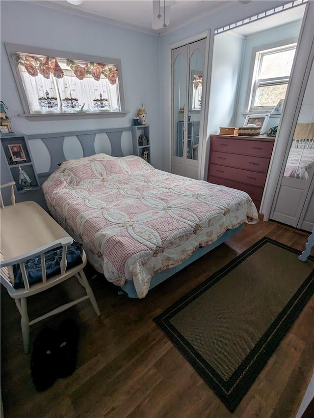 bedroom with a closet, ornamental molding, and hardwood / wood-style flooring