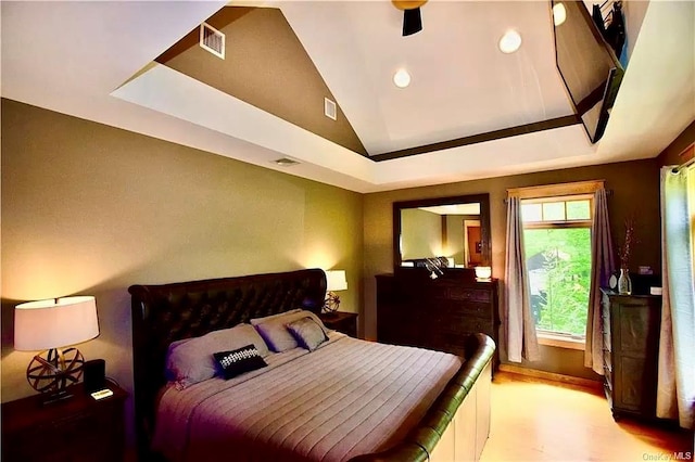 bedroom with a tray ceiling, ceiling fan, and lofted ceiling