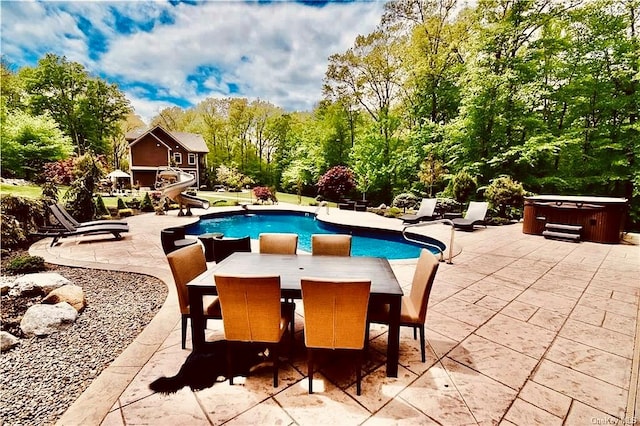 view of pool featuring a patio and a hot tub