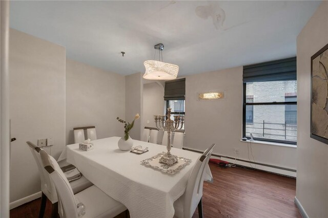 dining room featuring dark hardwood / wood-style floors and a baseboard heating unit