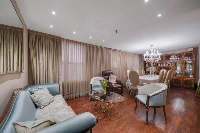 sitting room with wood-type flooring and a chandelier