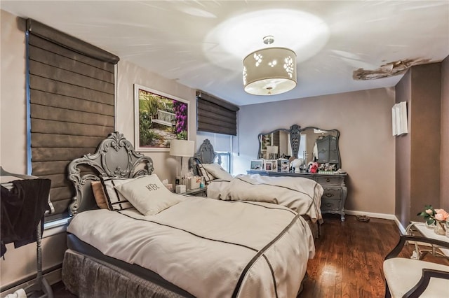 bedroom with dark hardwood / wood-style floors