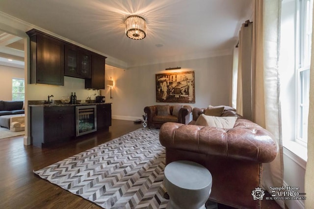 living room featuring dark hardwood / wood-style floors, crown molding, and beverage cooler