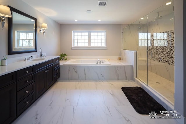 bathroom featuring vanity, separate shower and tub, and a healthy amount of sunlight