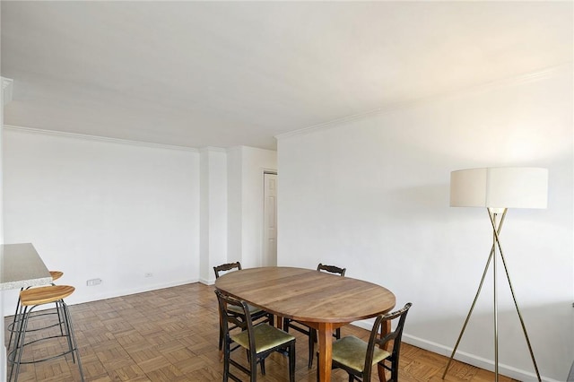 dining room featuring dark parquet floors and ornamental molding