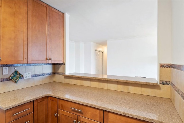 kitchen featuring decorative backsplash and light stone counters