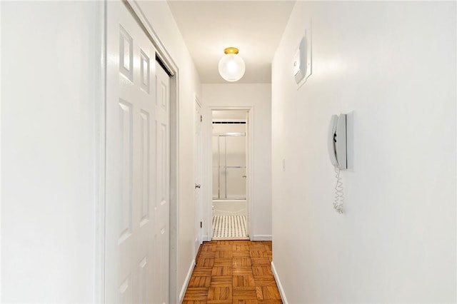 hallway featuring parquet flooring