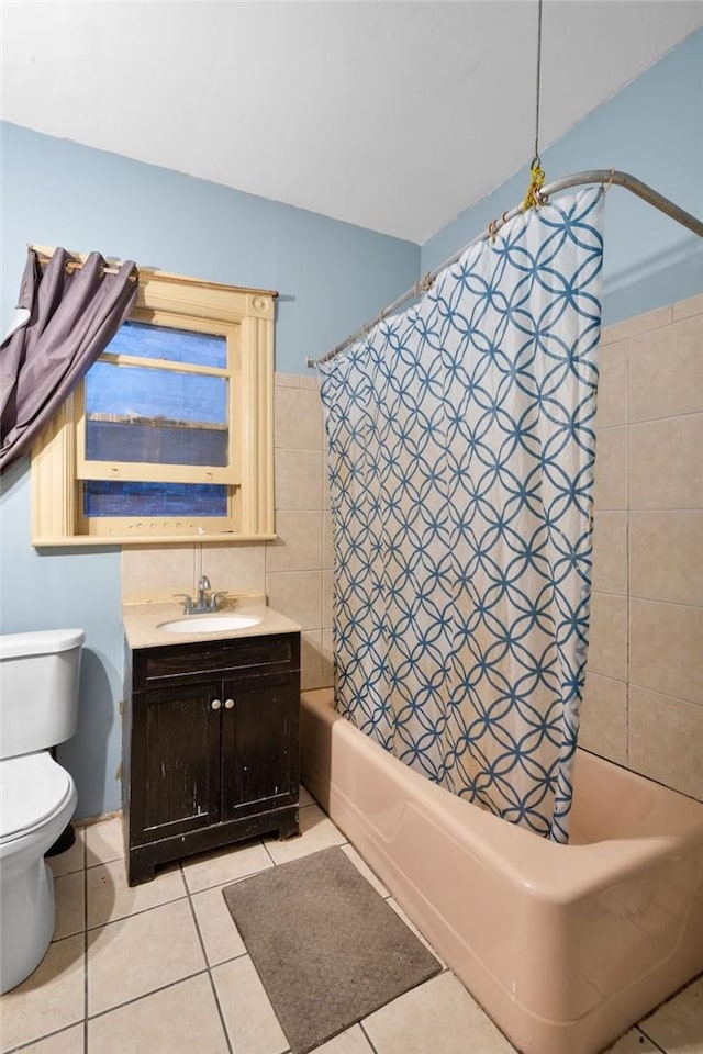 full bathroom with toilet, shower / tub combo with curtain, vanity, and tile patterned flooring