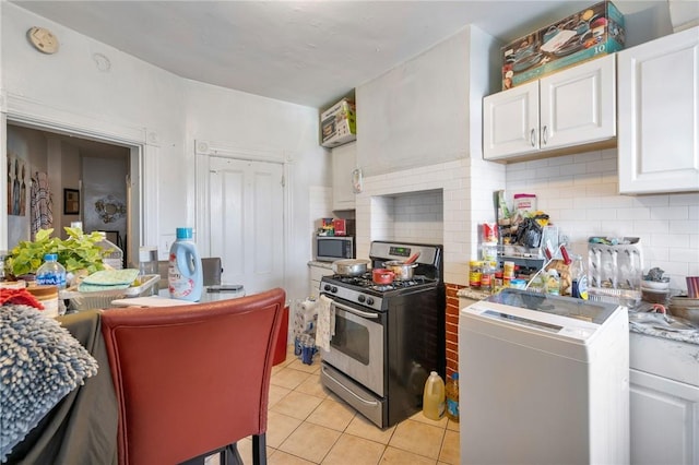 kitchen with white cabinets, light tile patterned floors, stainless steel appliances, and tasteful backsplash