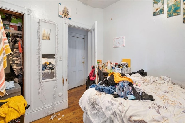 bedroom featuring hardwood / wood-style flooring and a closet