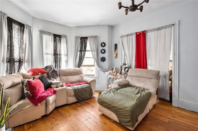 living area with wood-type flooring and a notable chandelier