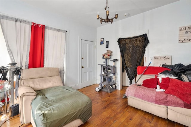 bedroom featuring a closet, a notable chandelier, and hardwood / wood-style flooring