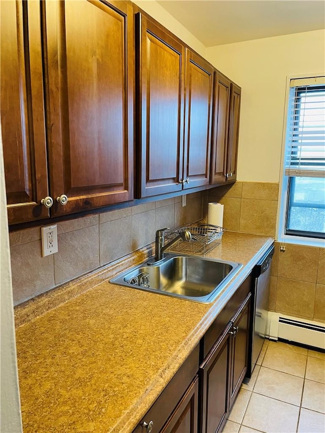 kitchen with backsplash, stainless steel dishwasher, sink, a baseboard radiator, and light tile patterned flooring