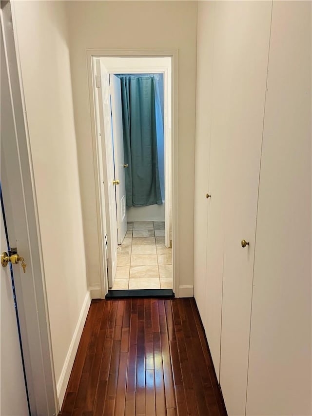 hallway with dark hardwood / wood-style flooring