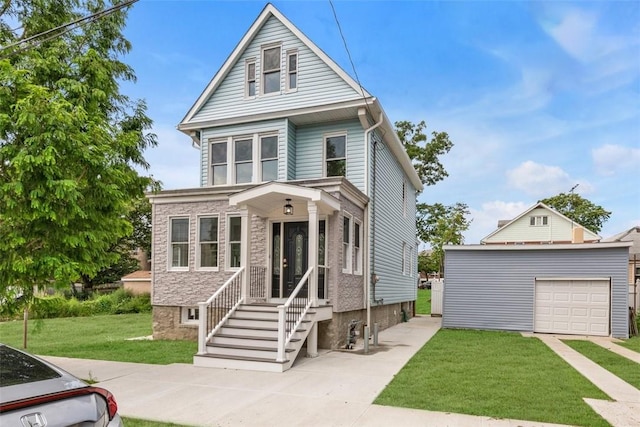 view of front facade featuring a front yard, an outbuilding, and a garage